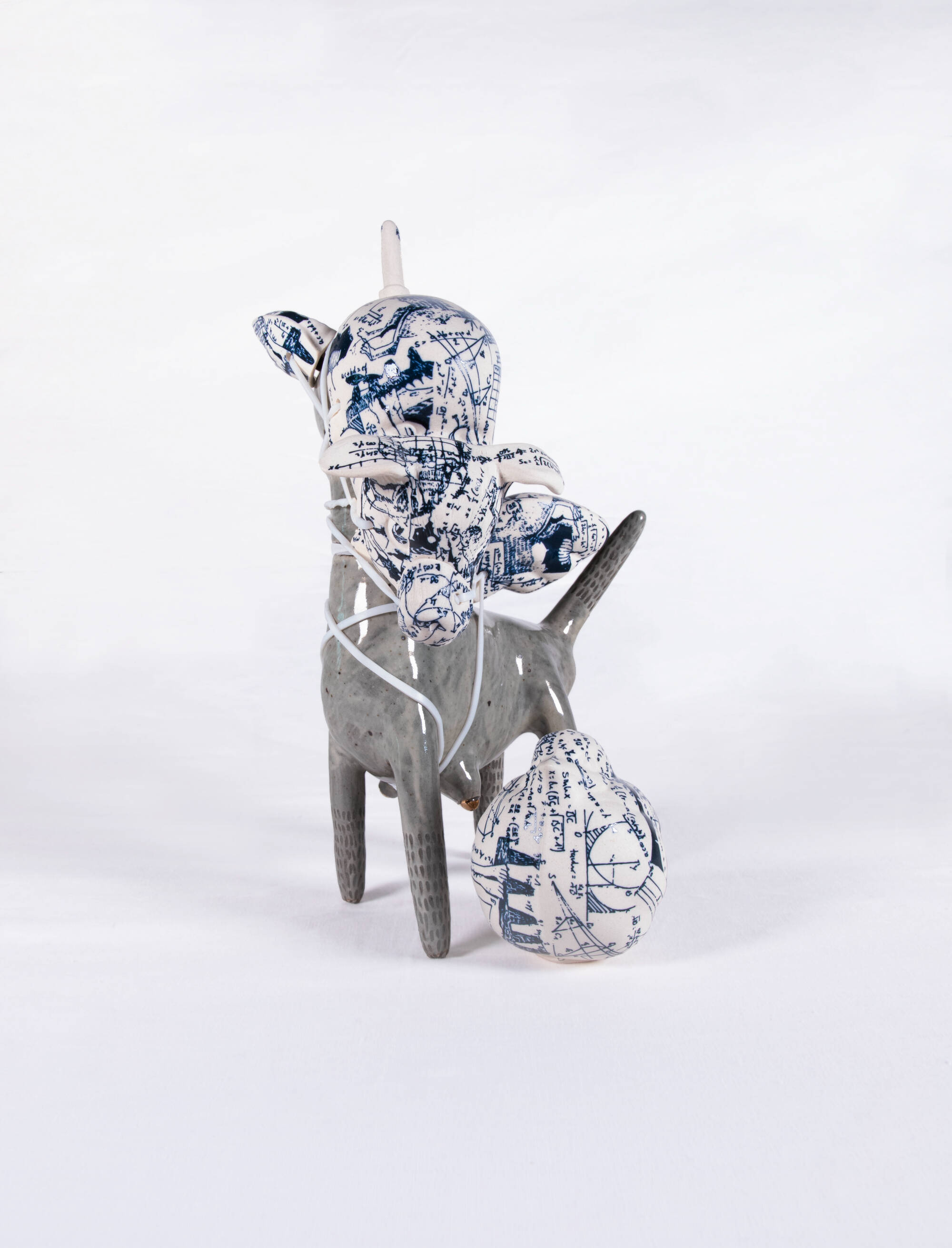 Deer like ceramic animal with blue and white porcelain covering its face.